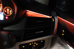 Ambient lighting reaches out on the dashboard, end to end. Also seen here are the dual AC vents