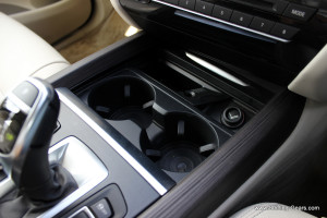 Two cup holders, a lighter and a cubby hole below the centre console
