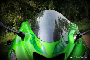 Windscreen is bubble shaped, and works perfect in deflecting wind when you lean forward