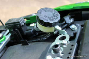 Rear disc brake oil filler is located under the seat