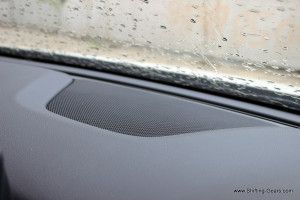 A speaker placed on top of the dashboard