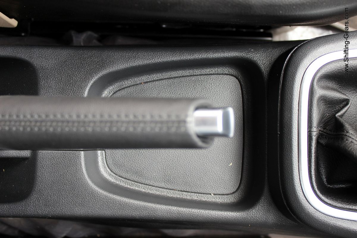Storage spot under the handbrake, too small to accommodate your smartphone though