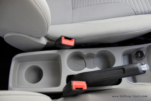 A total of three cup holders around the handbrake