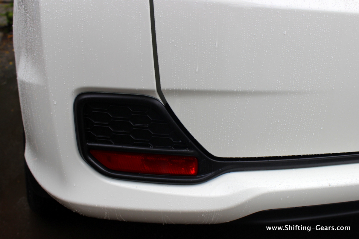 Reflector on either side of the rear bumper
