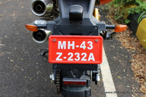 Rear mudguard and the number plate mount